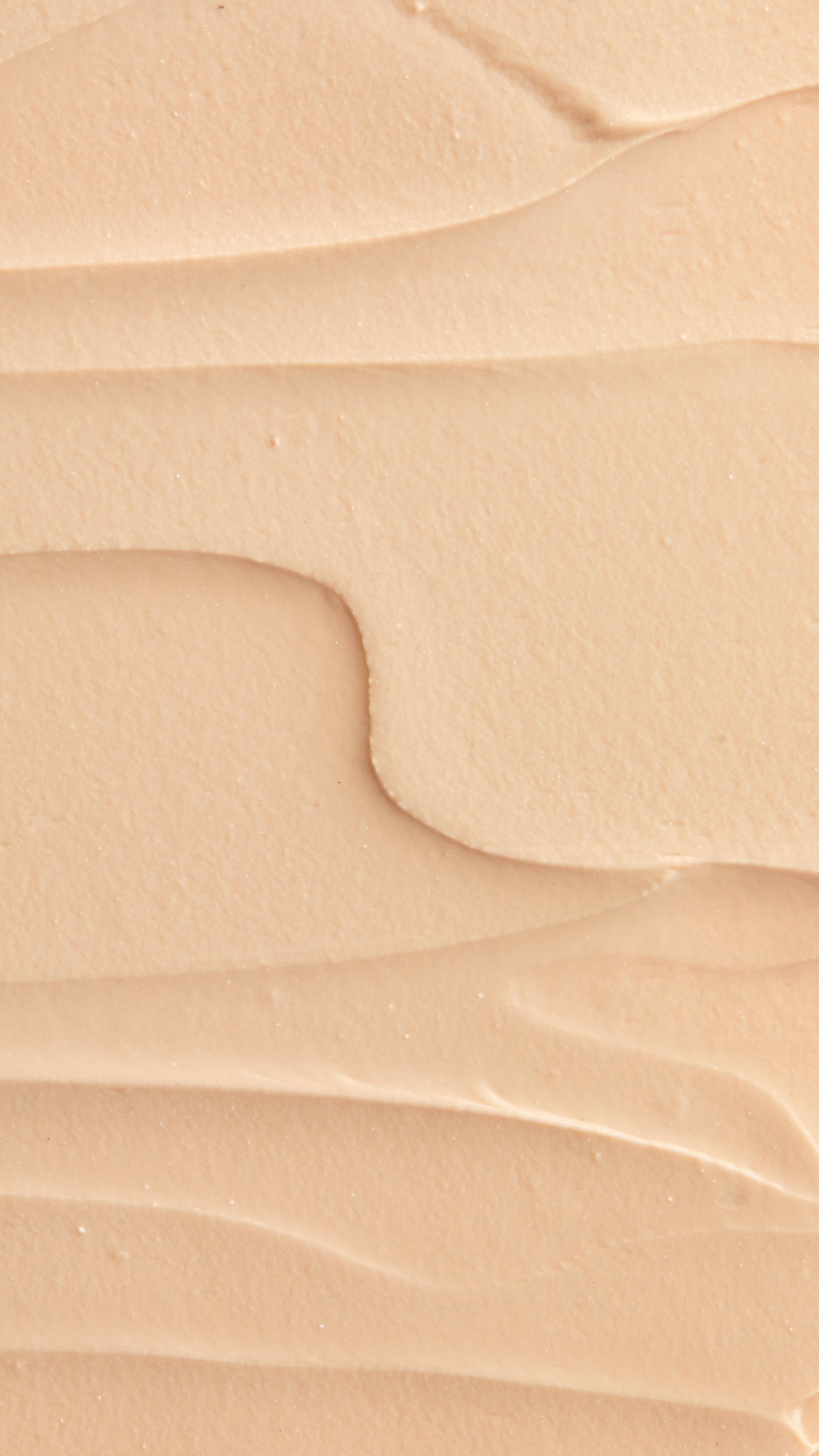 A super close-up image of the creamy, smooth Coconut Shie face mask product, focusing on the thick consistency.