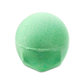 A bright green, spherical bath bomb called Avobath Bath bomb with a speckled texture. The round top tapers into a faceted base, all set against a solid black background.