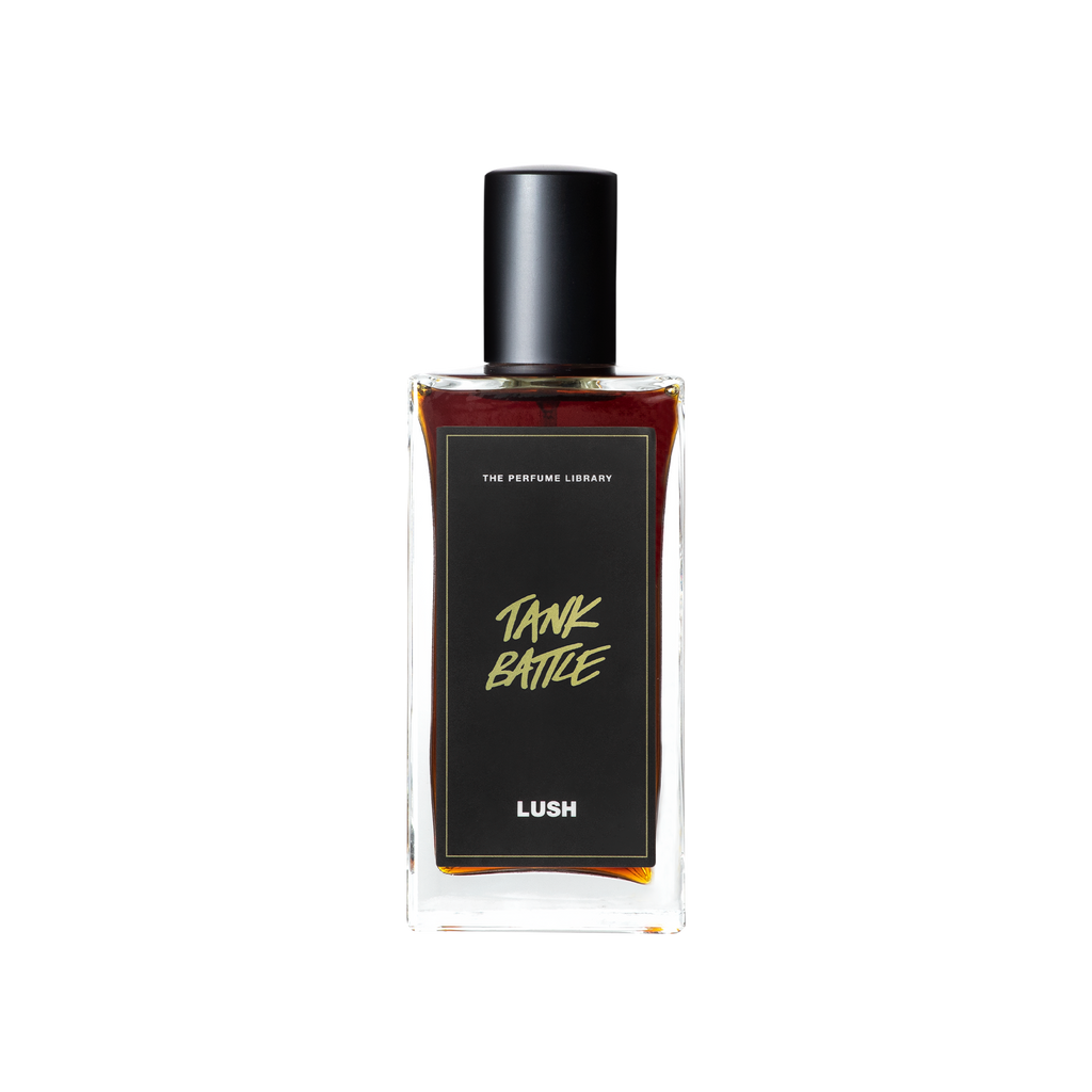 A glass perfume bottle filled with deep mahogany coloured liquid. A black label reads 'The Perfume Library' and 'Tank Battle'.
