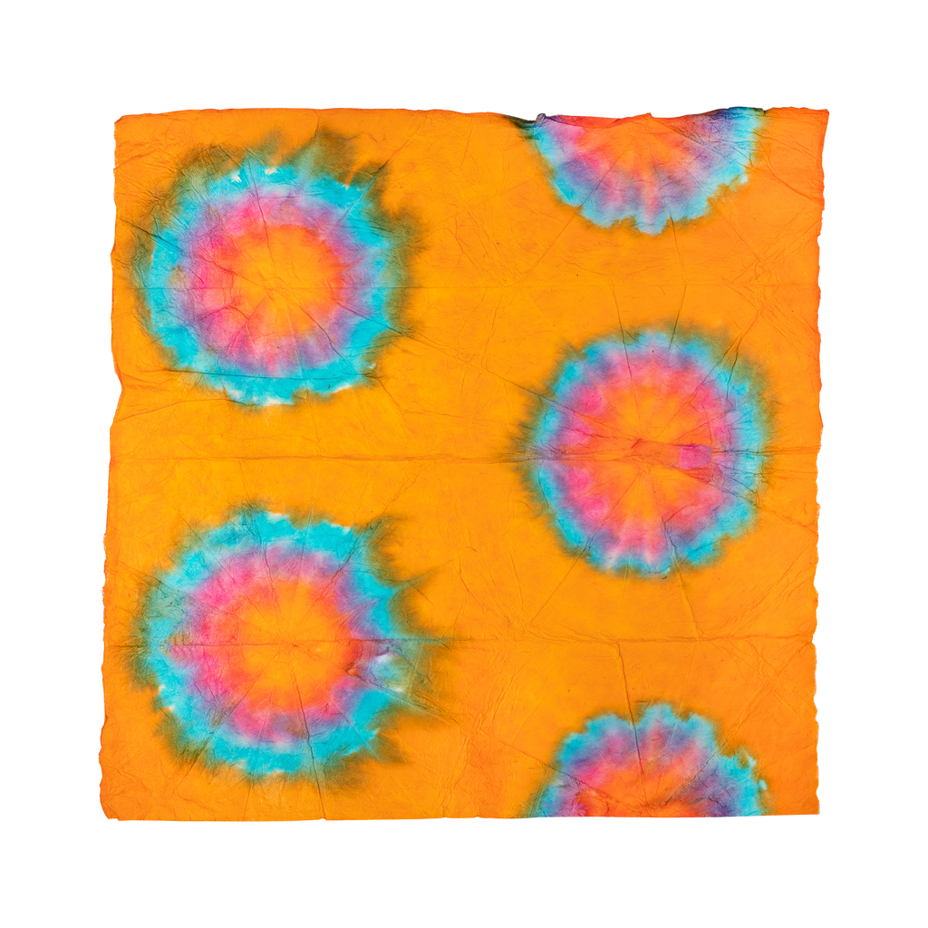 A square Lokta Wrap with orange, red and blue tie-dyed designs all over.